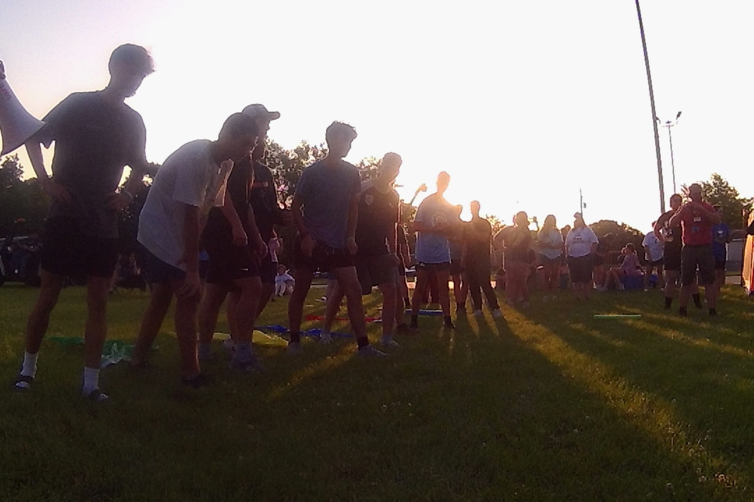 youth running a race at sunset