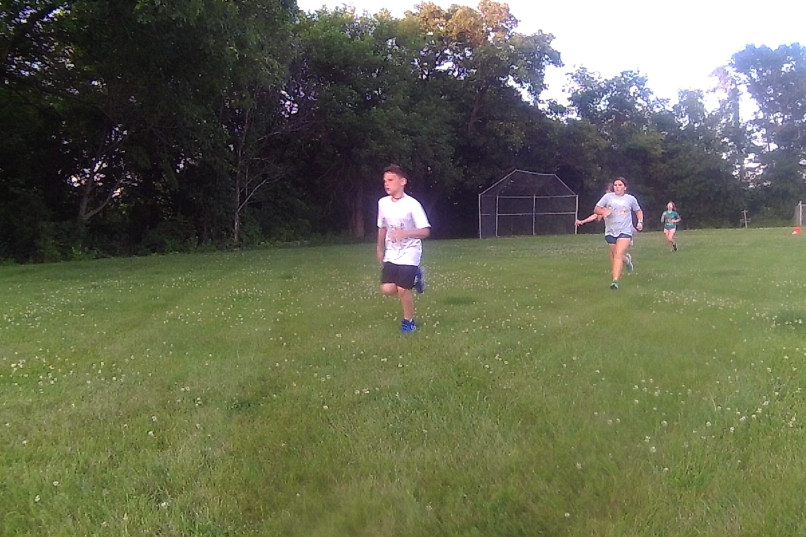 youth running in a cross-country race at Great Lakes Bible Camp
