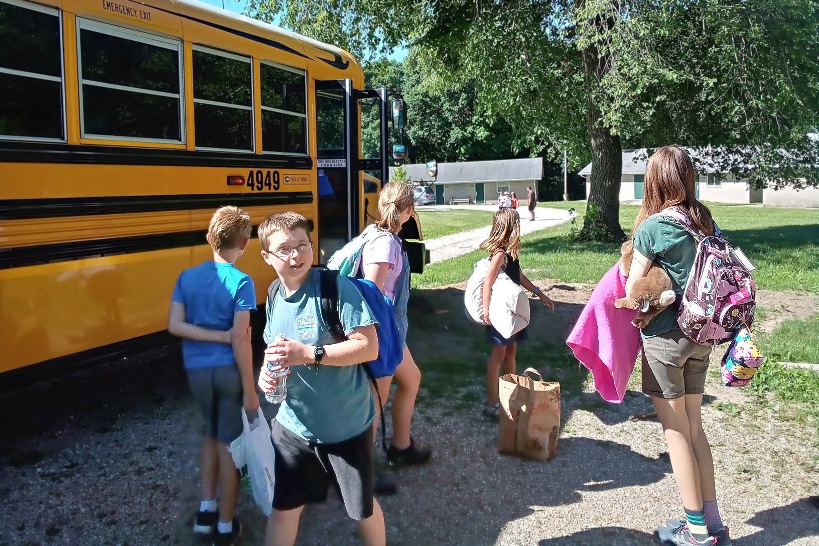 campers unload from bus at Great Lakes Bible Camp