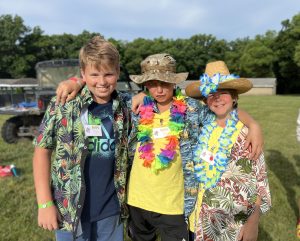 three boys wearing Hawaiian shirts at Great Lakes Bible Camp