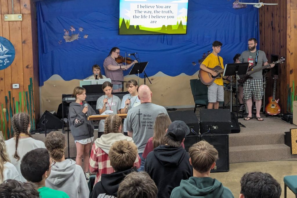 Campers leading music during chapel service