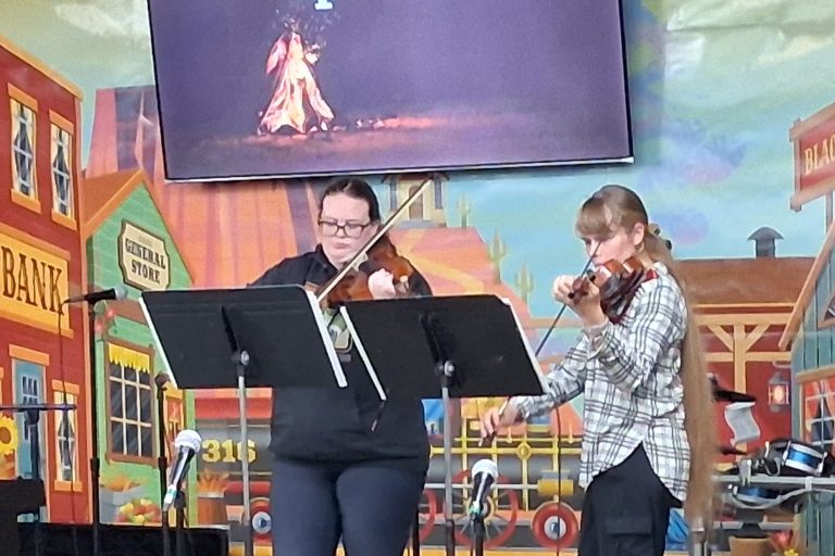 Young women playing a viola and violin duo