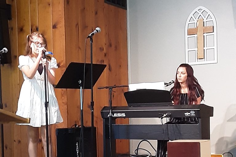 Girls singing in worship service