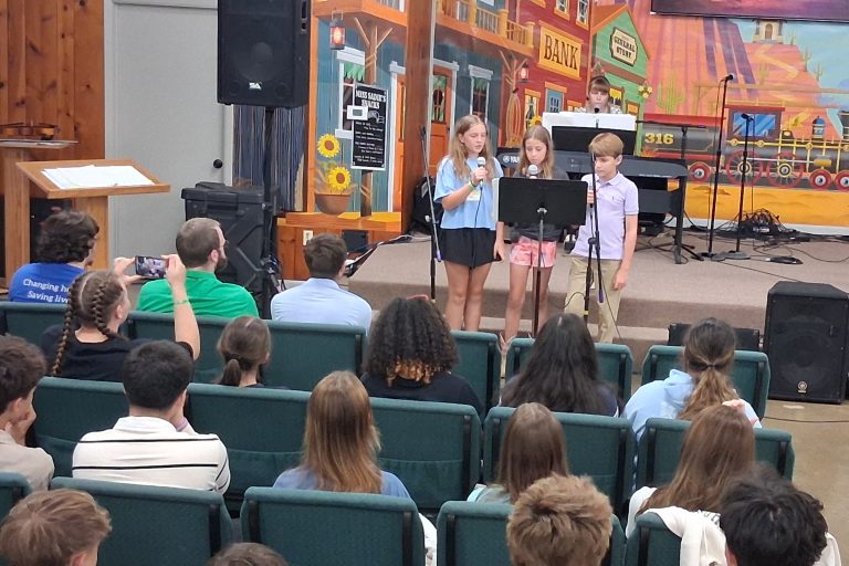 Three youth singing a hymn